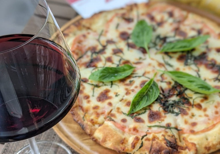 cheese pizza and a glass of profile four red wine from BOXT